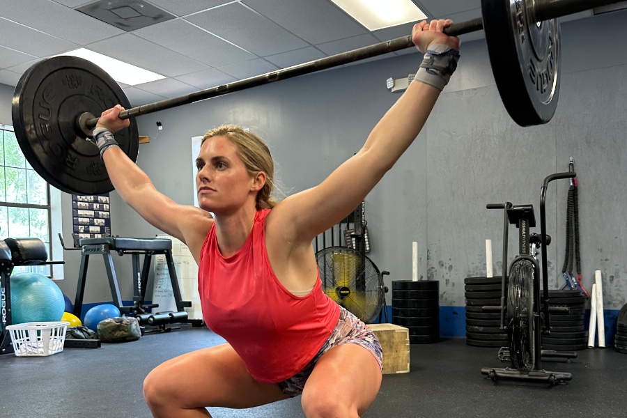 Caroline holding an overhead squat during a Crossfit workout