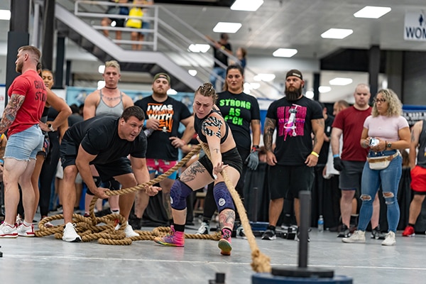 Shannon pulling a sled with during the sled rope pull